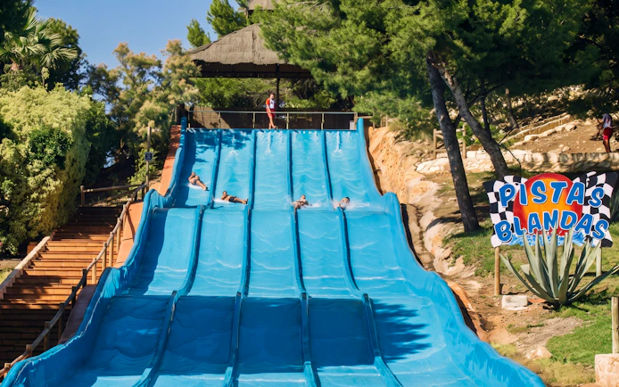 Aqualandia Benidorm water slide with people sliding down in Spain.