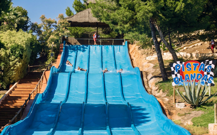 Aqualandia Benidorm water slide with people sliding down in Spain.