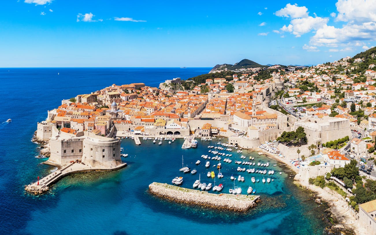 Aerial view of Dubrovnik's old city center with historic walls and Adriatic Sea, Croatia.