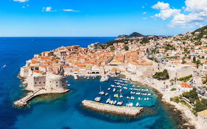 Aerial view of Dubrovnik's old city center with historic walls and Adriatic Sea, Croatia.