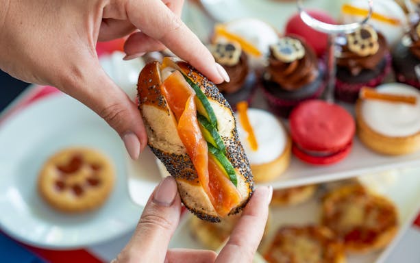 Smoked salmon sandwich and pastries on Paddington Afternoon Tea Bus.