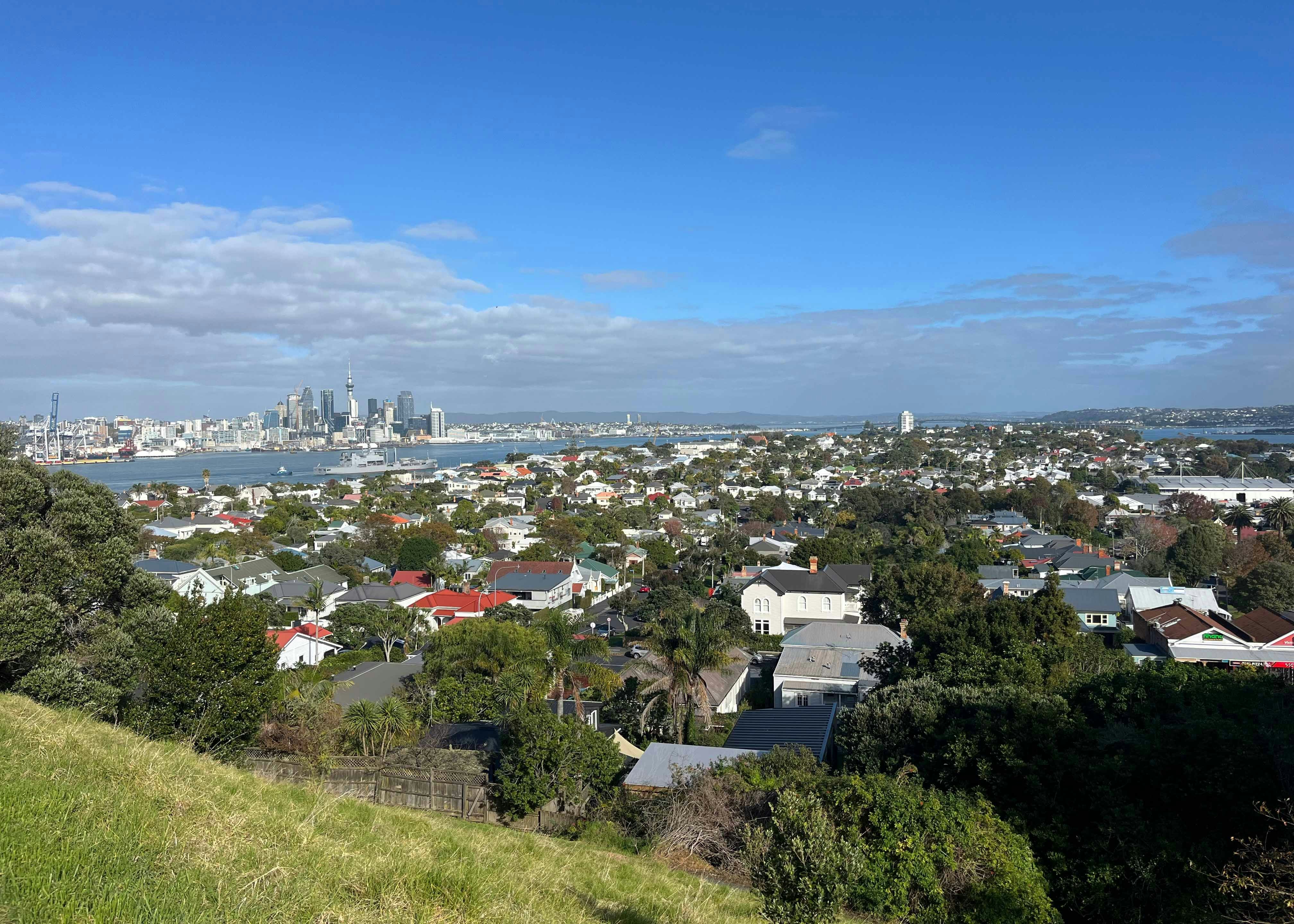 Aerial view of Devonport with Auckland skyline in the background.