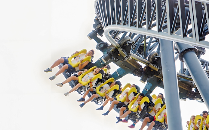 Riders on the Tornado roller coaster at Parque de Atracciones de Madrid.