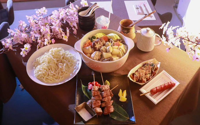 Chanko-nabe hot pot with noodles and skewers at Sumo Practice Show, Ochiizumibeya, Japan.