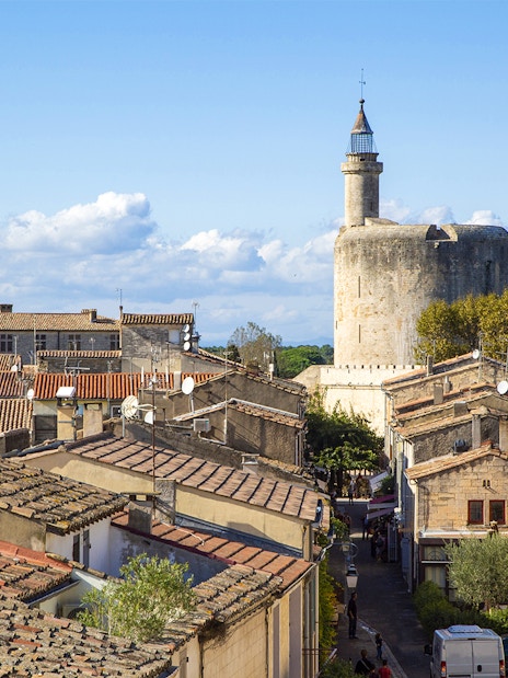 Towers and ramparts of Aigues-Mortes with view of medieval stone structures and rooftops.