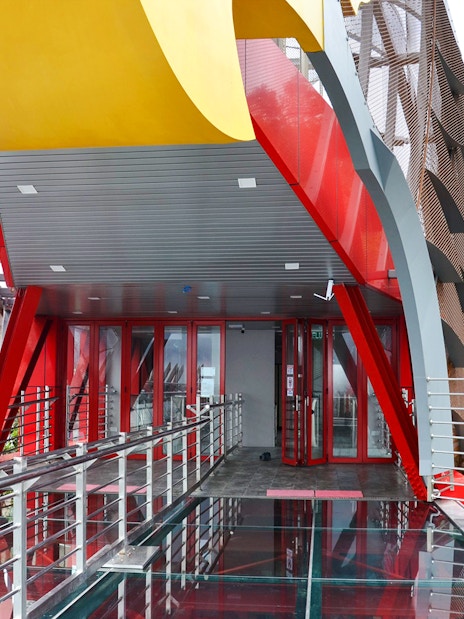 Langkawi Skywalk entrance with glass floor and red steel beams.
