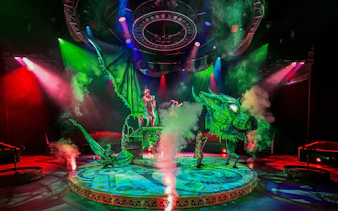 Performers with dragon puppet on stage at CARO Theatre Show, Efteling.