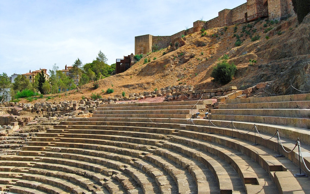Roman Theater steps with Alcazaba Castle in the background, Málaga walking tour.