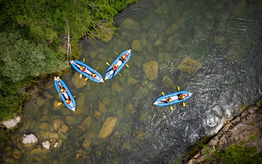 Kayakers navigating a river during a canyoning experience from Split.