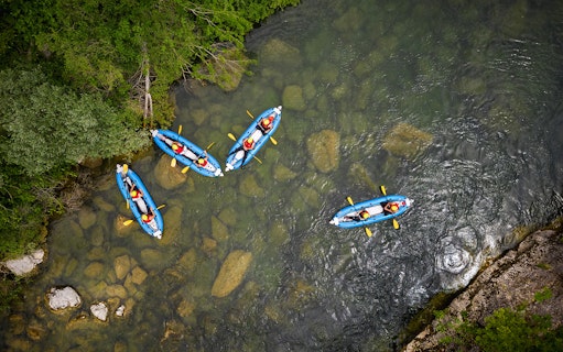 Kayakers navigating a river during a canyoning experience from Split.