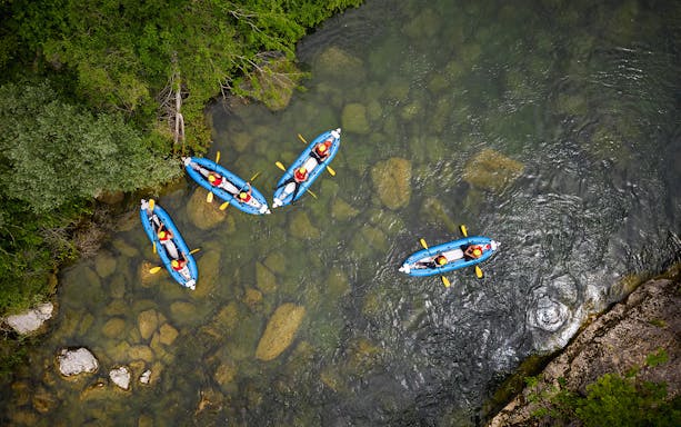 Kayakers navigating a river during a canyoning experience from Split.