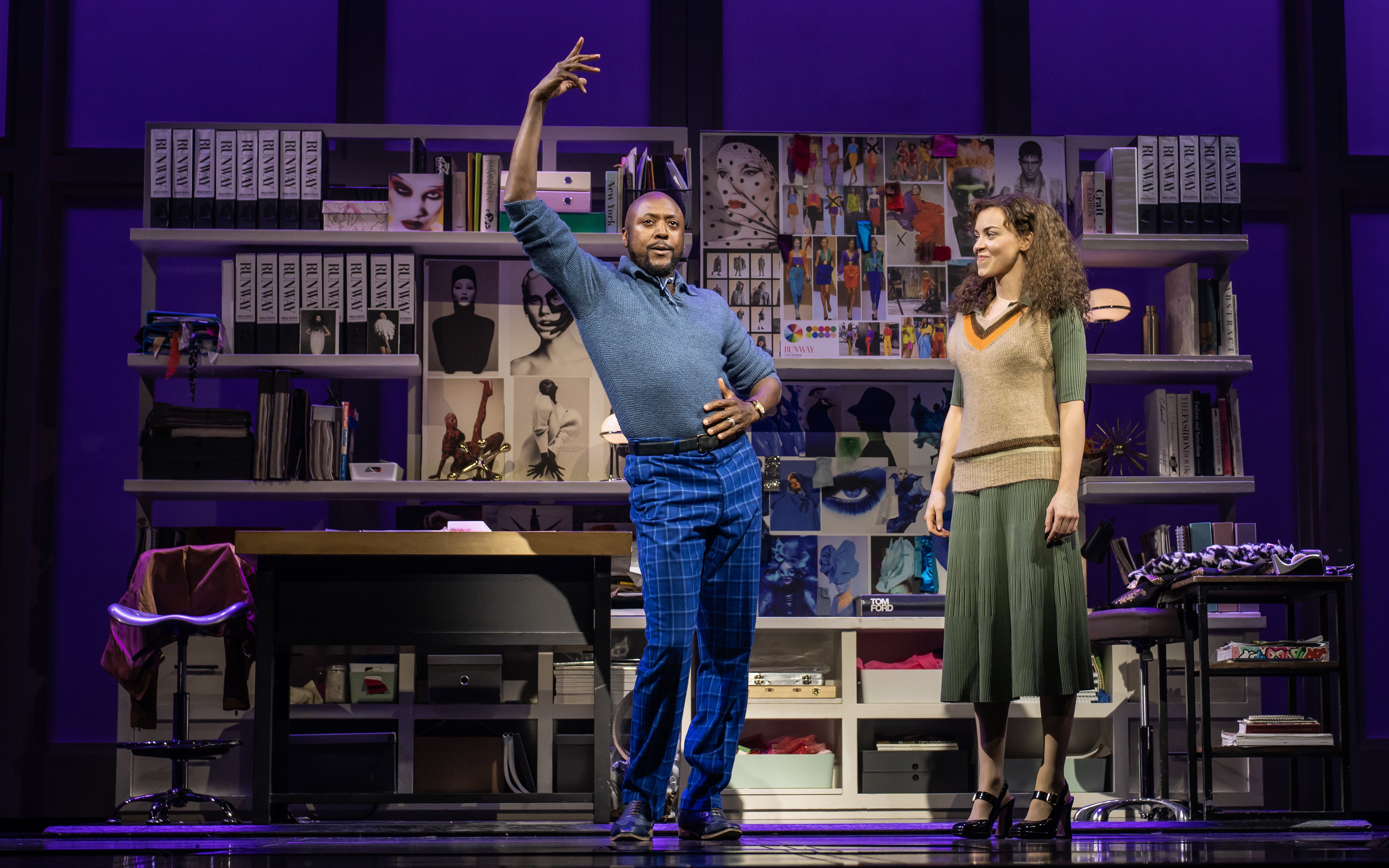 Stage scene from The Devil Wears Prada Westend show with two actors in a fashion office setting.