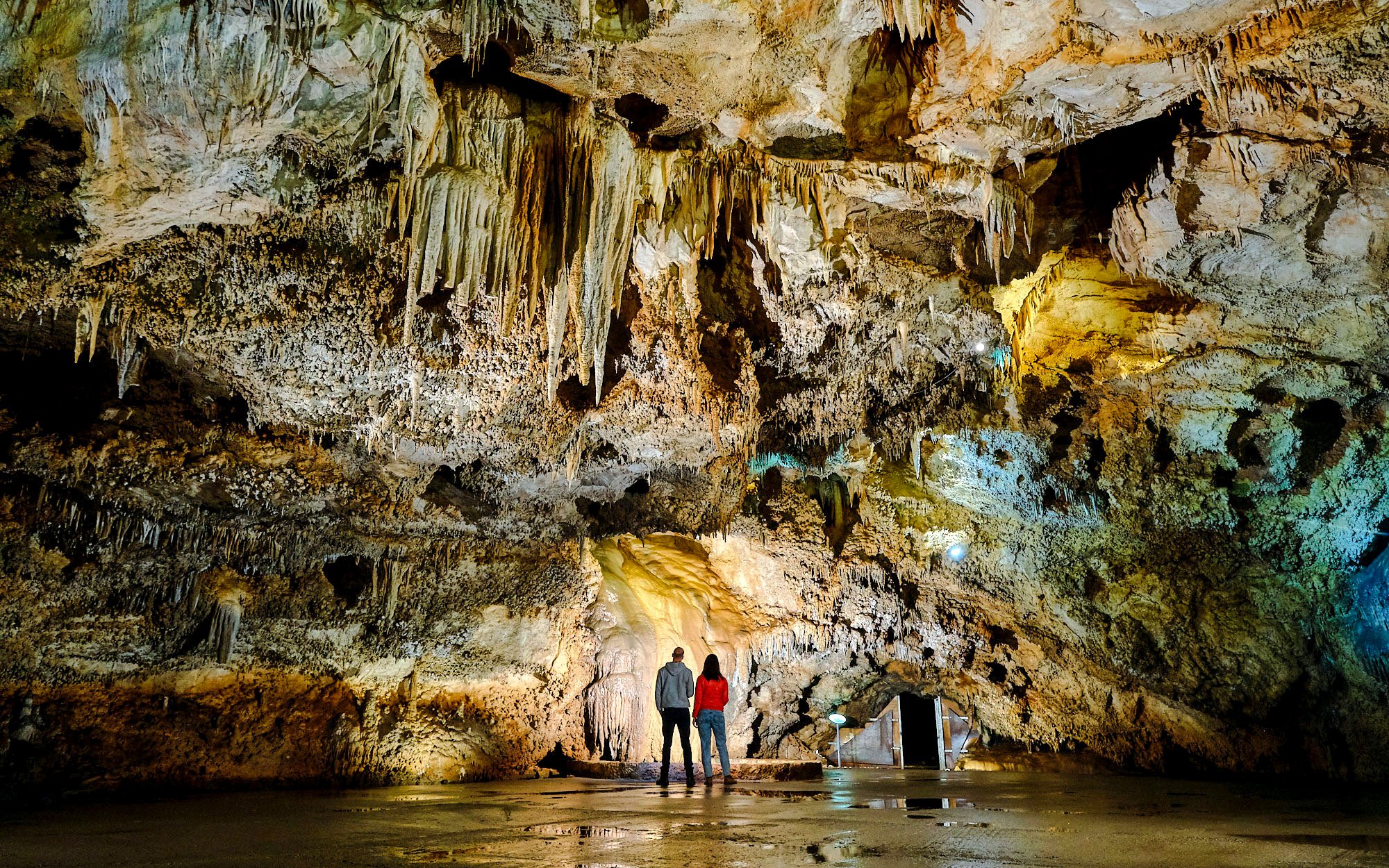 Tourists exploring stalactites inside Lipa Cave, Cetinje.