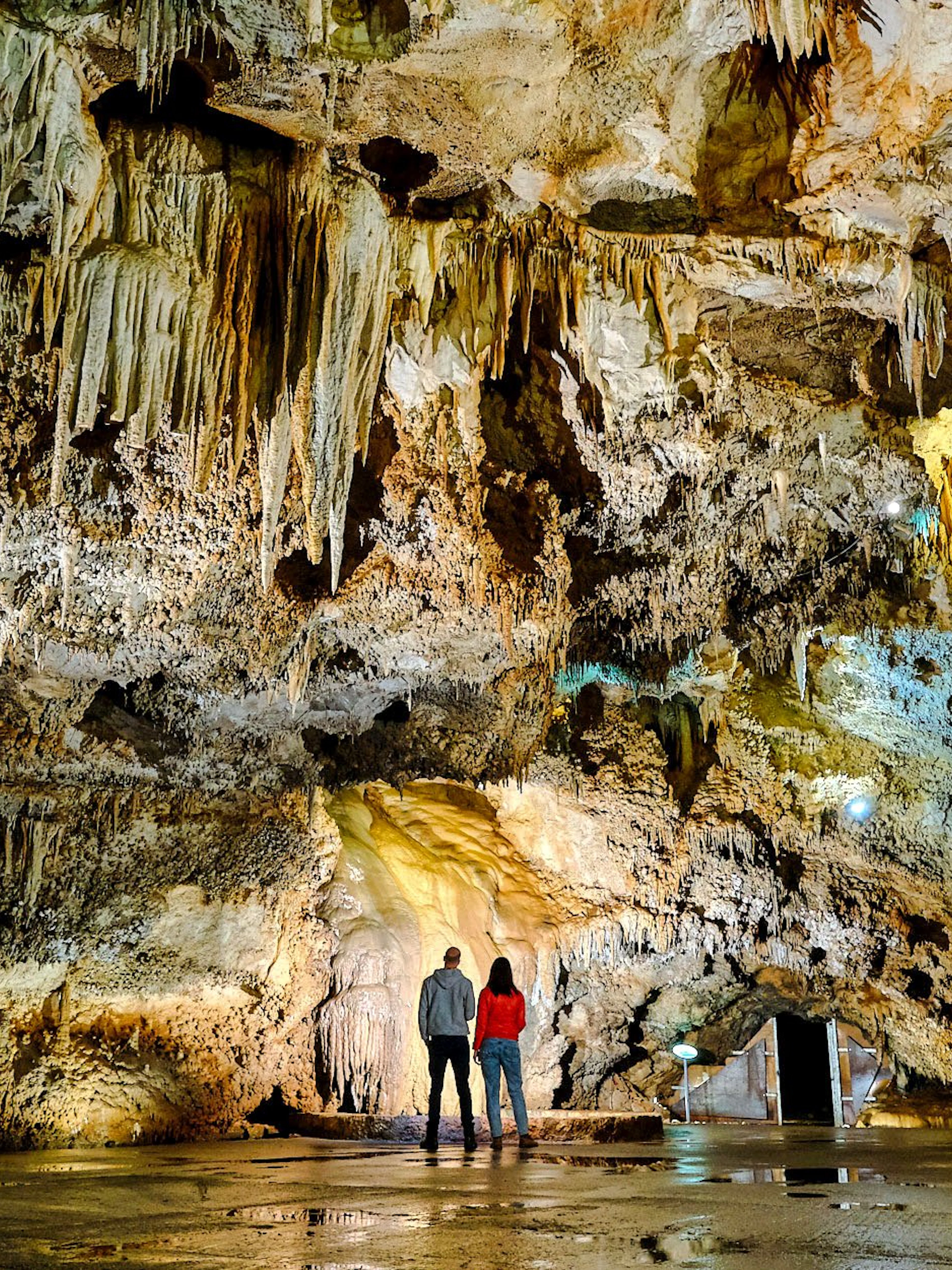 Tourists exploring stalactites inside Lipa Cave, Cetinje.