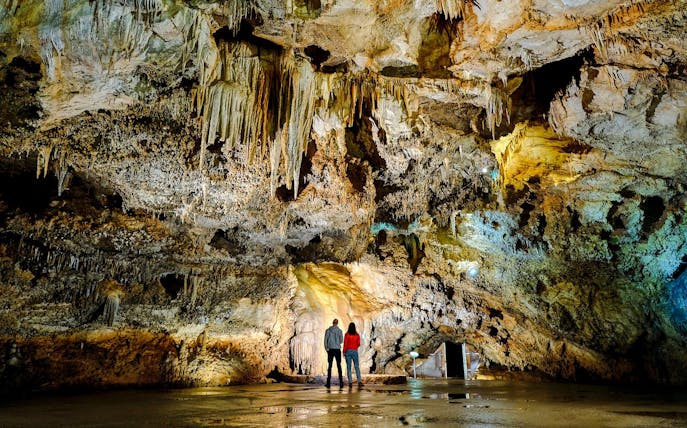 Tourists exploring stalactites inside Lipa Cave, Cetinje.