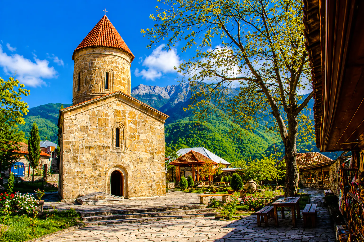 Kish Church with mountain backdrop on Sheki, Khan's Palace & Kish Village tour from Baku.