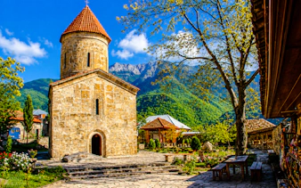 Kish Church with mountain backdrop on Sheki, Khan's Palace & Kish Village tour from Baku.