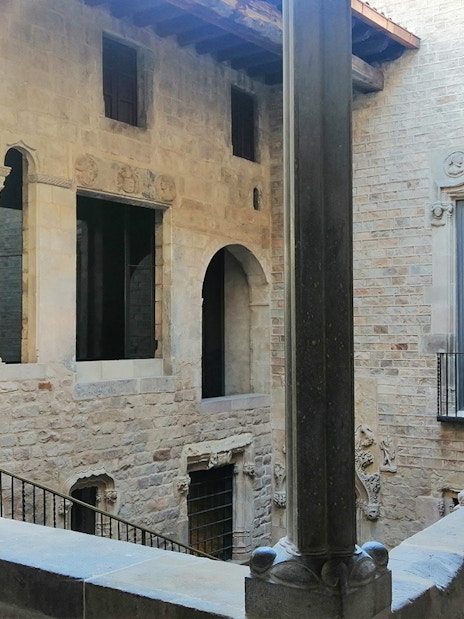 Stone courtyard with arches and columns at Picasso Museum, Barcelona.