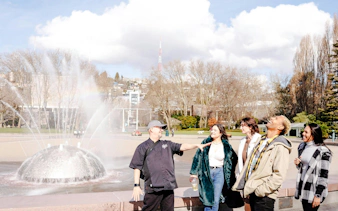 Visitors enjoying the International Fountain at Seattle Center during a food tour.