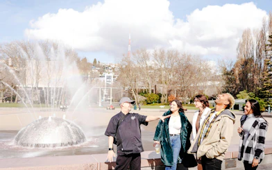 Visitors enjoying the International Fountain at Seattle Center during a food tour.