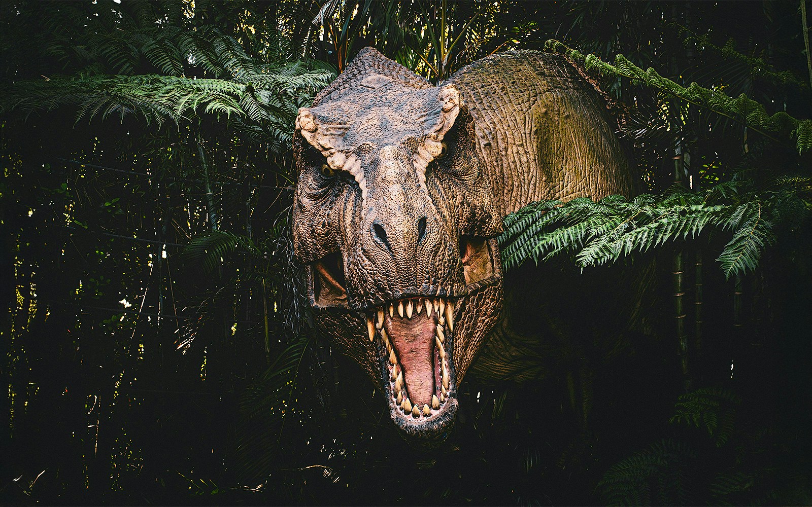 Trex emerging from bushes at Jurassic Park attraction, london