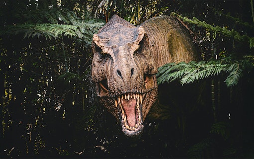Trex emerging from bushes at Jurassic Park attraction, london