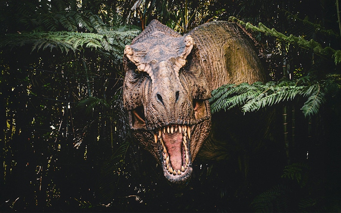 Trex emerging from bushes at Jurassic Park attraction, london
