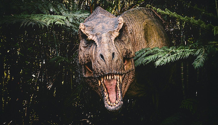 Trex emerging from bushes at Jurassic Park attraction, london