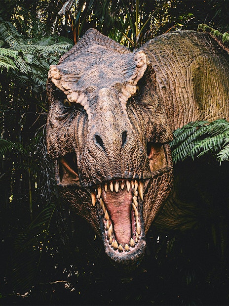 Trex emerging from bushes at Jurassic Park attraction, london