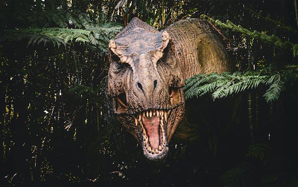 T-rex emerging from bushes at Jurassic Park attraction, Islands of Adventure, Universal Orlando.