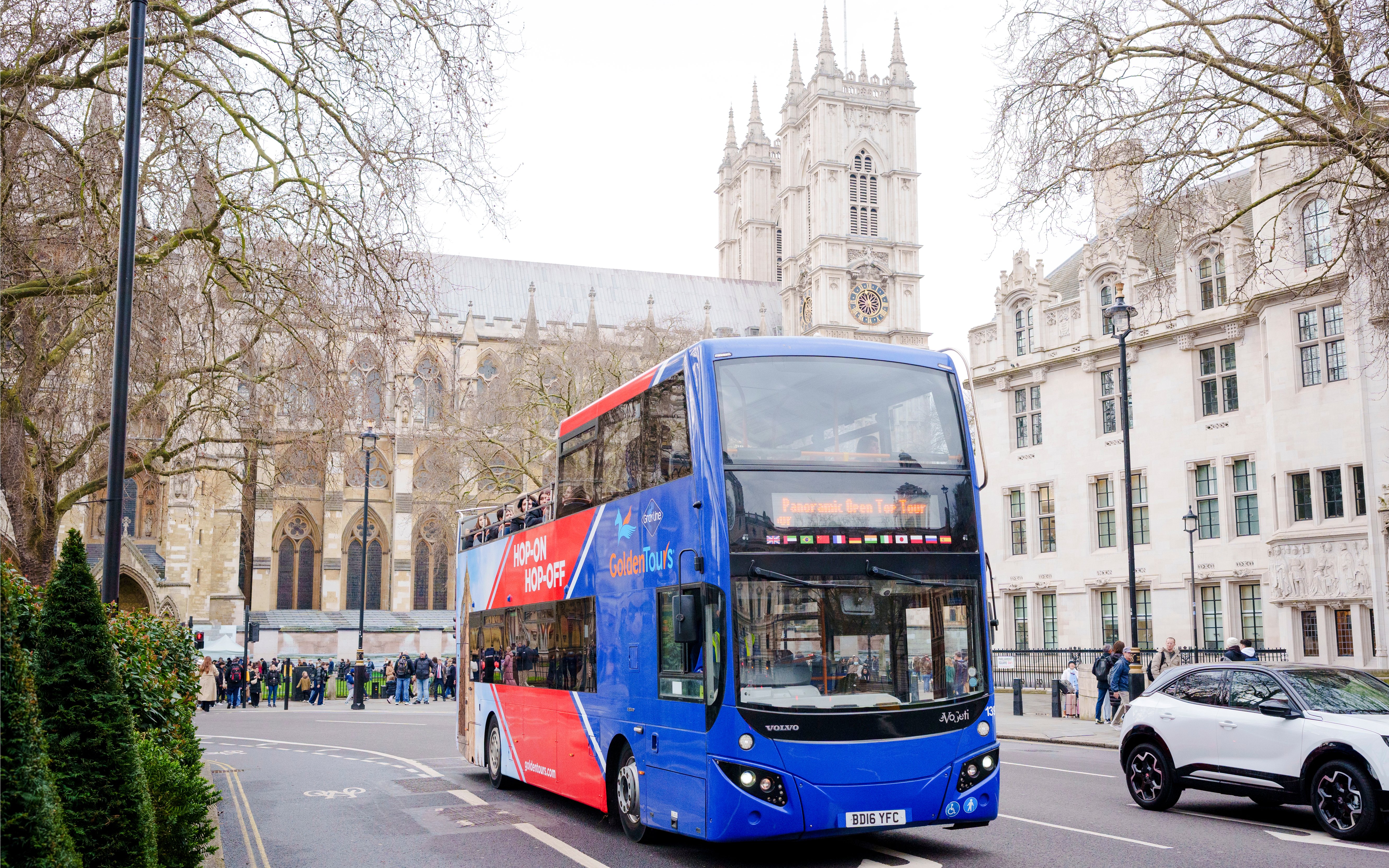 Golden Tours hop-on hop-off bus near Westminster Abbey, London.