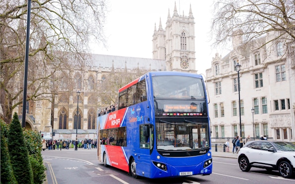 Golden Tours hop-on hop-off bus near Westminster Abbey, London.