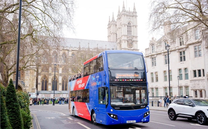 Golden Tours hop-on hop-off bus near Westminster Abbey, London.