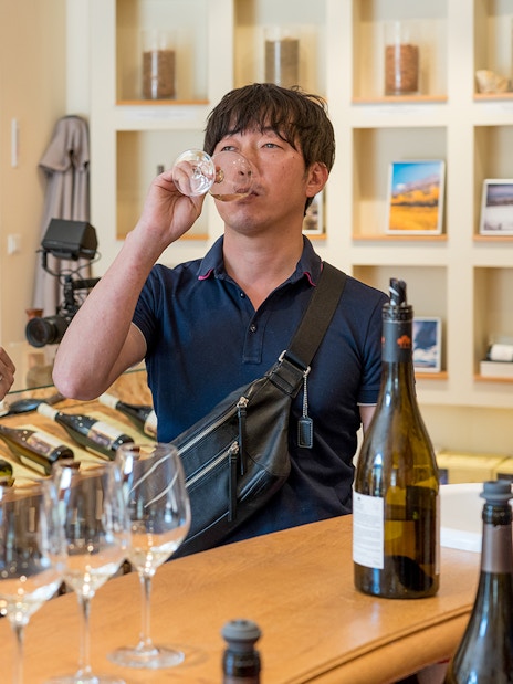 Couple tasting wine at a winery in Avignon, France.