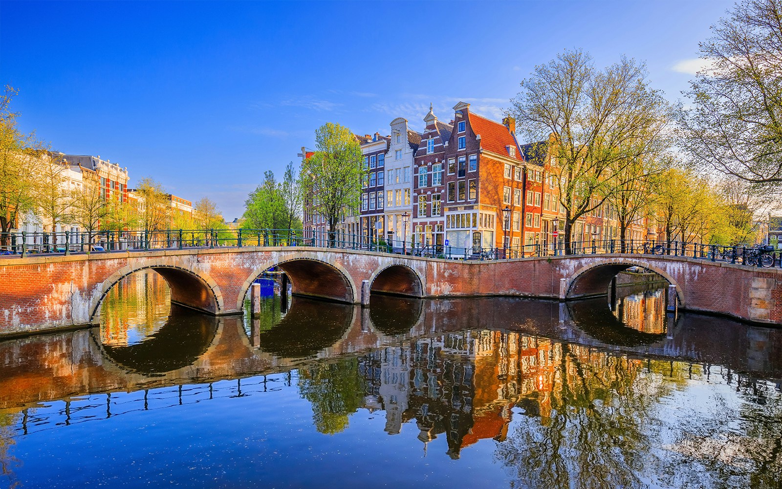 Keizersgracht canal with arched bridge and historic buildings in Amsterdam.