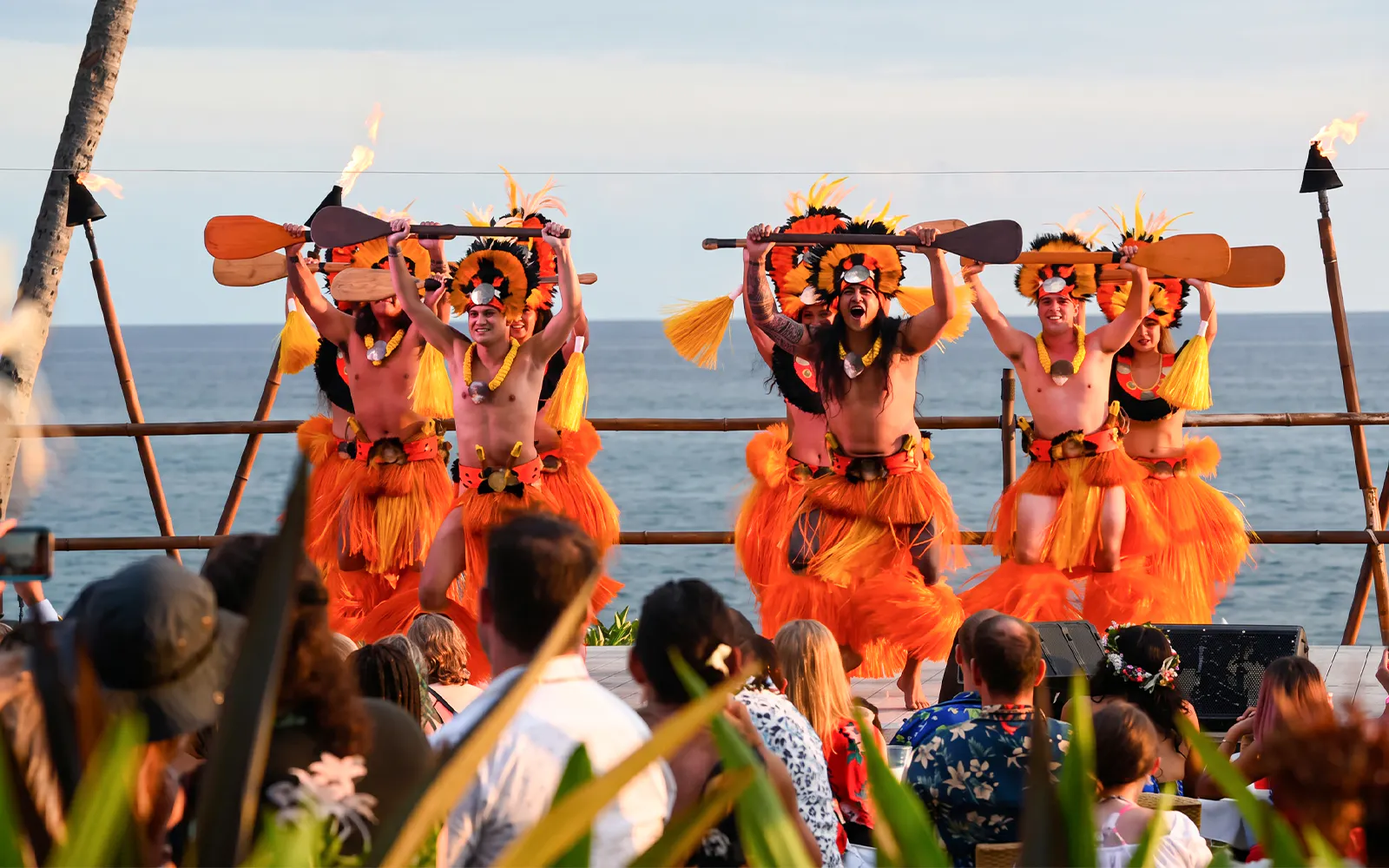 Performers in traditional attire at Voyagers of the Pacific Luau dance show.