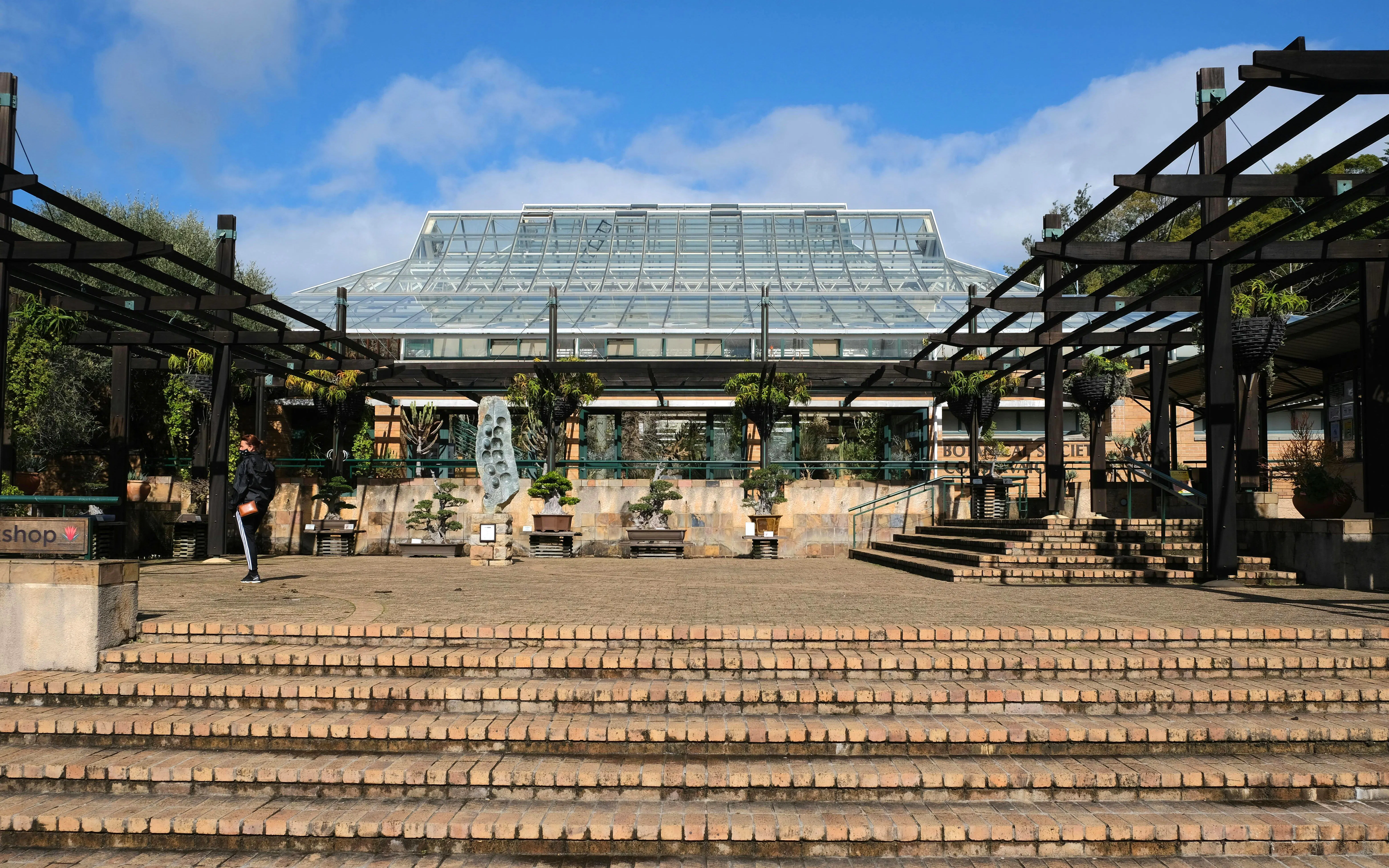 Kirstenbosch Botanical Garden entrance with glass conservatory and stone steps.