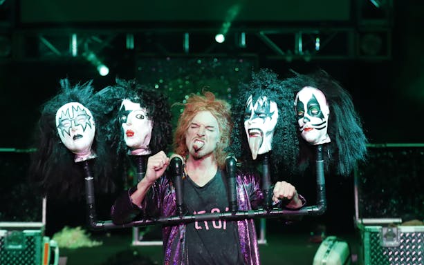 Performer with rock band masks at Carrot Top show in Las Vegas.