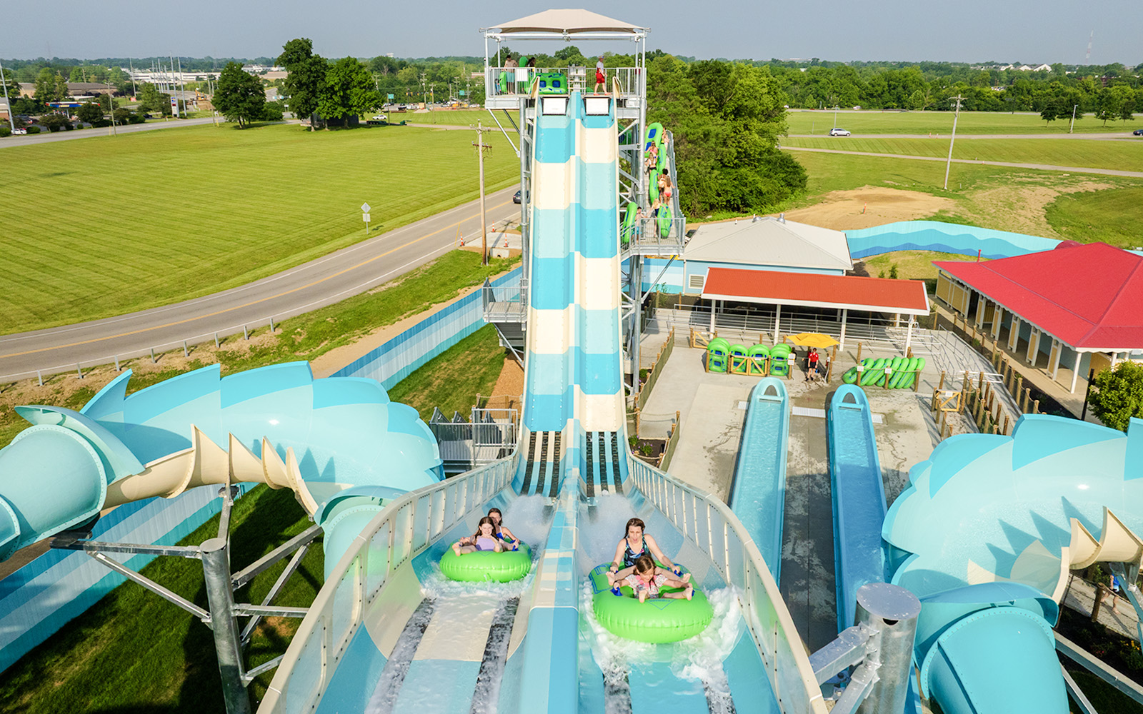 Water slide riders at RiverRacers, Kings Island, descending on inflatable tubes.