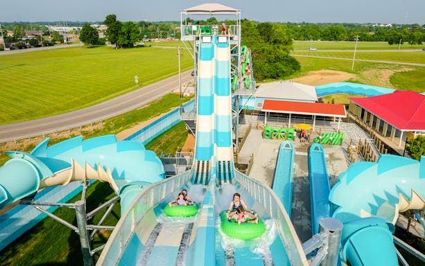 Water slide riders at RiverRacers, Kings Island, descending on inflatable tubes.