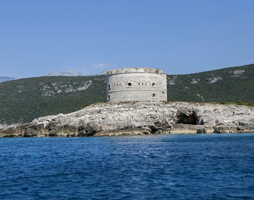 Old fort overlooking Boka Bay with surrounding mountains in Montenegro.