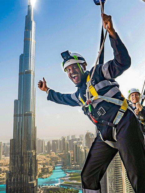 Visitors enjoying the Sky Views experience with Burj Khalifa in the background, Dubai.