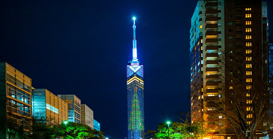 Fukuoka Tower with cityscape view, Japan, highlighting ticket availability.