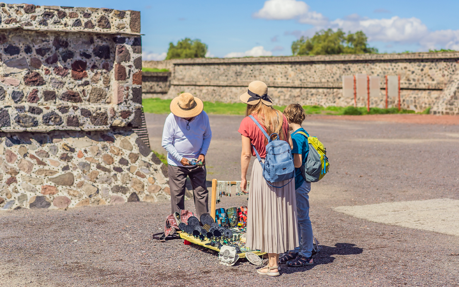 Mexican vendor selling crafts at Teotihuacan, Mexico with pyramids in the background.