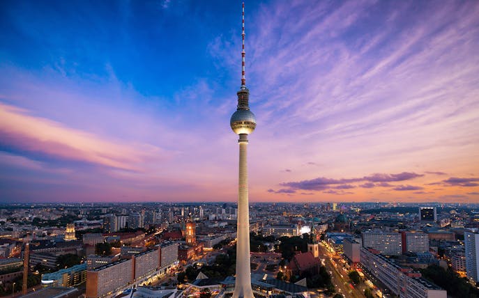 Berlin TV Tower at sunset with cityscape view.