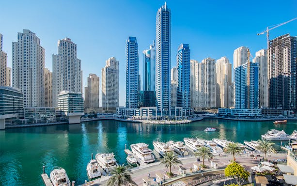 Dubai Marina skyline with yachts docked, seen during a guided boat tour.