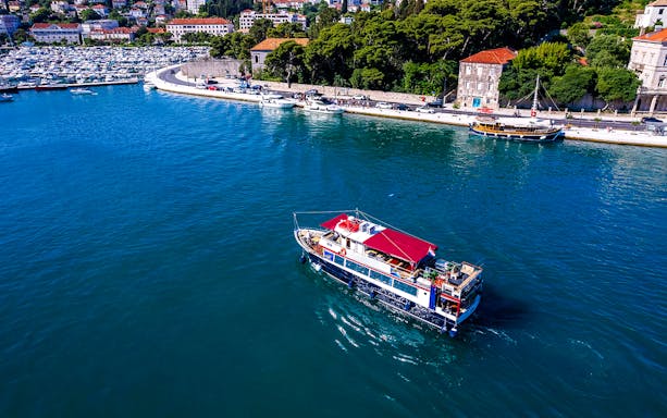Cruise ship sailing near Dubrovnik coast on Elaphite Island tour.