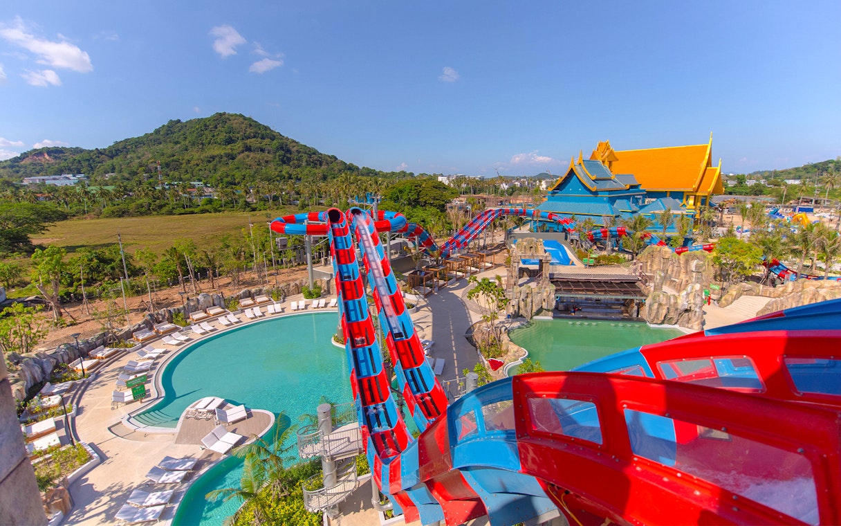 Water slide at Andamanda Phuket with pool and scenic mountain view.