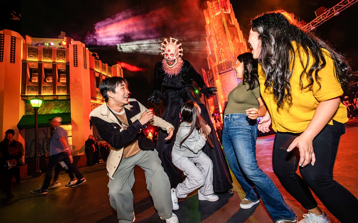 Guests reacting to a costumed performer at Hollywood Horror Nights, Universal Studios Hollywood, Los Angeles.