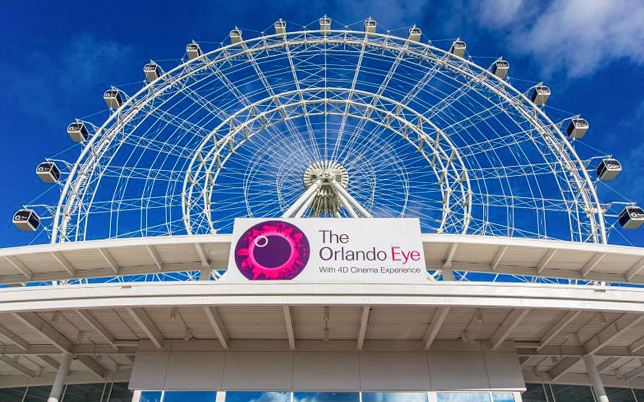 Ferris wheel at ICON Park, Orlando, with blue sky background.